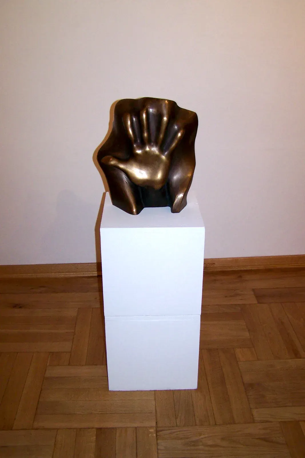 Pamięci Emila „B” — Il bronzo su un plinto bianco, in una sala dal parquet a spina: quarantadue centimetri, all’altezza dello sguardo.