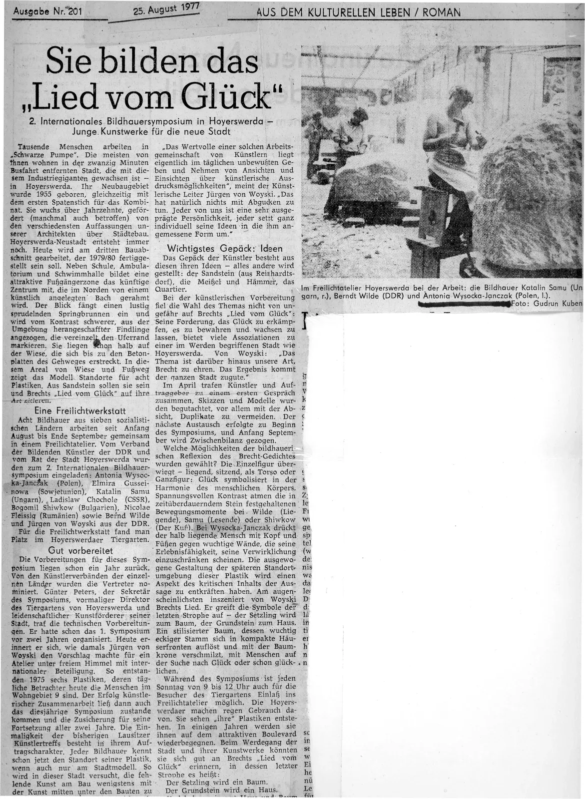 Ritaglio di giornale sul 2° Simposio internazionale di scultura di Hoyerswerda, 1977, con una foto degli scultori al lavoro nell'atelier all'aperto.